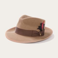 An icon of the Stetson brand, the Whippet Fedora epitomizes the sophisticated style of the American post-war era with its timeless, versatile profile and a brim that can look casual and cool when snapped up, or snapped down for a dressed-up and dapper look. Handcrafted with a firm finish from high-quality 100% wool felt and richly dyed in versatile shades, the Whippet features a slightly tapered 4 ½" pinch front teardrop crown and a 2 ⅜” bound edge brim. Its classic style is underscored by a gro Classic Brown Felt Hat With Flat Crown, Classic Curved Brim Felt Hat For Fall, Classic Felt Hat With Curved Brim For Fall, Brown Fedora For Kentucky Derby And Formal Occasions, Flat Crown Fur Felt Fedora, Classic Beige Fedora Felt Hat, Beige Wool Fedora With Curved Brim, Classic Fedora With Curved Brim For Fall, Classic Curved Brim Fedora For Fall