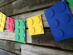 some lego blocks are hanging on a clothes line