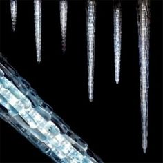 icicles are hanging from the ceiling in front of a black background with white text