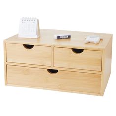 a wooden dresser with two drawers and a remote control