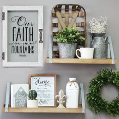 two wooden shelves with plants and pictures on them