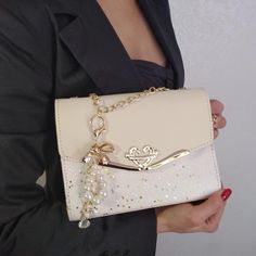 "Champagne Evening Clutch designed to be worn on the shoulder or in the hand long gold chain to wear on the shoulder internal mobile phone pocket inside zip pocket with external quick release decorative pearl beads, crystal and gold bow key ring the bottom of the bag is made up of an extra layer that helps keep its shape MATERIALS: faux leather high quality vegan external quick release decorative pearl beads, crystal and gold bow key ring DIMENSIONS: Width: 8.0\" / 20 cm Height: 6.5\" / 16 cm Side: 3.0\" / 7 cm Length of chain (round)  43.3\" / 110 cm Questions or additional photos? Just ask.💕 Possible express delivery within 4-10 days. Cost from 25 dollars. Etsy: https://www.etsy.com/shop/gorgeouslily Facebook :https://www.facebook.com/lilly.yavorskaya Instagram:https://www.instagram.com Wedding Party Bags, Prom Bag, Bridal Clutch Bag, Clutch Bag Wedding, Bridal Purse, Beige Handbags, Festival Earrings, Sparkly Wedding, Beaded Evening Bags