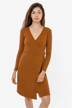 This classic wrap dress is made of a 2x1 ribbed heavy cotton spandex, with a feminine drape and stretch. This dress features long sleeves, an integrated front slit and a-line mid-length skirt and comes with a long tie that can be worn to the front or back. Perfect for date nights but also casual enough for everyday wear. Try pairing with tights and heels or a matching wrap coat. We recommend sizing down in this style if you prefer a more fitted look. This item is a garment dye product. Garment d Wrap Dress Styles, Tights And Heels, Ginger Dress, Los Angeles Apparel, Cherry Dress, Date Nights, Wrap Coat, Mid Length Skirts, Black Wrap Dress