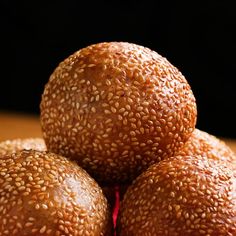 three sesame seed balls stacked on top of each other