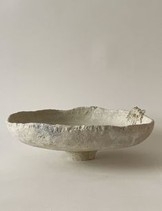 a white bowl sitting on top of a table