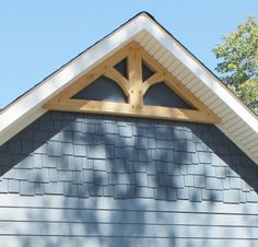 the top of a house with a roof made out of wood and shingles on it