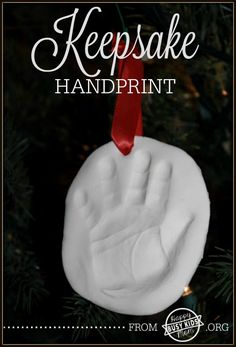 a handprint ornament hanging from a christmas tree with the words keepsake handprint on it