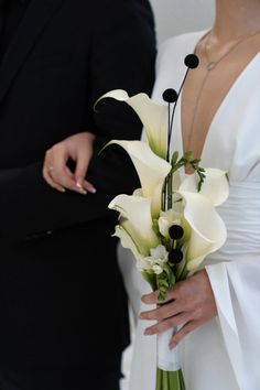 a bride and groom standing next to each other