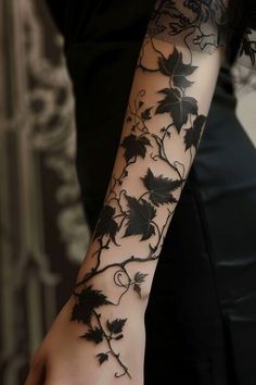 a woman's arm with vines and leaves on it