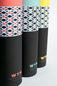 four different colored paper cups sitting next to each other on a white surface with the words wyw printed on them