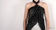 a woman wearing a black and white polka dot halter top with an asymmetrical neck tie