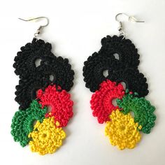 two pairs of crocheted black, yellow and red earrings with flowers on them