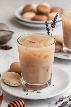 two glasses of iced coffee with lavender sprigs on the rim and cookies in the background