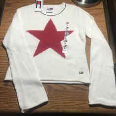 This Tommy Hilfiger Sweater Is Winter White With A Red Wool Blend Star On The Front. The Sweater Is 100% Cotton. Girl's Size Small. New With Tags. Tommy Hilfiger Outfits Women, Tommy Hilfiger Outfits, Star Sweater, Tommy Hilfiger Sweater, Tommy Hilfiger Shirts, White Star, Red Wool, Girls Sweaters, Winter White