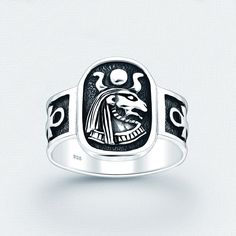 a silver ring with an image of a bird on it's face and the words,