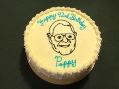 a birthday cake with an image of a man's face on the frosting