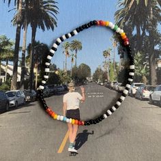 glass seed bead bracelet with black, white and rainbow pattern strung on elastic please gently roll off and on to prolong its life handmade in venice, ca Black Seed Bead Bracelet, Black Heishi Beads Bracelet With Colorful Beads, Black Beaded Friendship Bracelets With Heishi Beads, Black Beaded Heishi Friendship Bracelets, Trendy Multicolor Beaded Bracelets With Black Beads, Casual Multicolor Beaded Bracelets With Black Beads, White Friendship Bracelets With Black Beads, Black Friendship Bracelets With Colorful Beads For Everyday, Black Friendship Bracelets With Colorful Beads