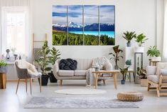 a living room filled with furniture next to a large window covered in plants and paintings