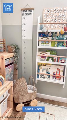 a child's room with bookshelves and toys on the floor, including a toy crib