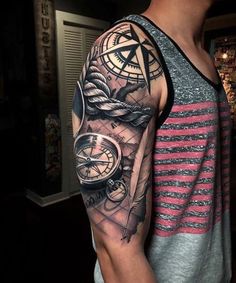 a man with a compass and rope tattoo on his arm