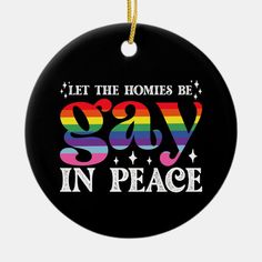 a black ornament that says let the homes be gay in peace