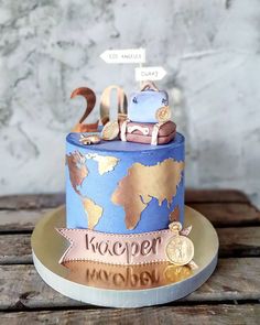 a blue and gold birthday cake sitting on top of a wooden table