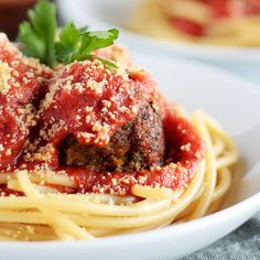 spaghetti with meatballs and parmesan cheese on top