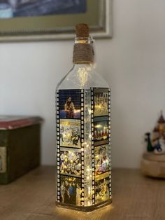 a bottle that has pictures on it with lights in the top and bottom, sitting on a table