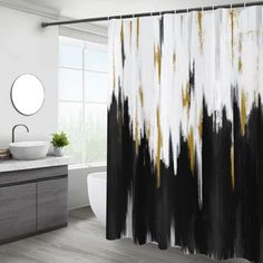 a black and white shower curtain with gold paint streaks on it in a modern bathroom