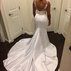 a woman in a white wedding dress looking at her reflection