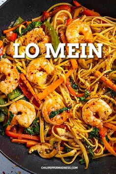 a wok filled with shrimp, carrots and noodles that says lo mein on the side