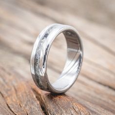 a wedding ring sitting on top of a wooden table