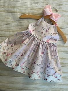 ★*.*'.*★Princess & Friends Toddler Dress★*.*'.*★ The dress is a sundress style, with extra long straps to make a fancy bow at the back.  The back has elastic for a snug fit. The bottom is trimmed with a Coordinating fabric  for an extra fancy style. Beautiful soft shade of pink. Ready to ship Available in sizes 2T & 3T Care Instructions: Dresses are made from 100% Cotton and wash best on cold / hang to dry to prevent shrinking* Playful Sleeveless Dress With Tie Straps, Spring Playtime Dress With Bow, Summer Cotton Dress With Bow Straps, Beach Cotton Dress With Bow, Cute Dresses With Spaghetti Tie Straps, Fitted Whimsical Twirl Dress For Summer, Whimsical Fitted Twirl Dress For Summer, Summer Princess Playtime Dress, Whimsical Cotton Twirl Dress For Summer