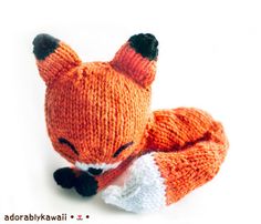 an orange knitted stuffed animal laying down