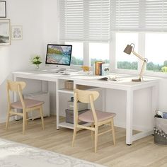 a white desk with two chairs and a computer on top of it in front of a window