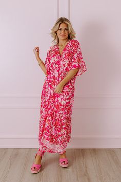 - Your style will blossom like a wildflower with this breezy dress! - Lightweight material with a pink hued floral print - A built-in partial skirt lining ending thigh length - A v-cut neckline with two hidden hook and eyes for additional coverage - Loose short sleeves - A cinched waistline with an elastic back - A flowy yet flattering silhouette that ends in a straight maxi length hemline Measurements S : Bust 34", Hip 36", Length 52", Sleeve Length 16", Waist 26-30". M : Bust 36", Hip 38", Len Pink Tropical V-neck Maxi Dress, Pink Floral Print V-neck Dress For Beach, Pink Floral Print A-line Maxi Dress, Pink Floral Print Summer Maternity Dress, Pink V-neck Maxi Dress With Vibrant Print, Breezy Dress, Loose Shorts, Floral Maxi, V Cuts