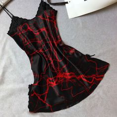 Indulge in luxurious comfort and stunning style with our Women's Red Lace Nightgown. Made with a smooth, stretchy, and lightweight fabric, this chemise offers a comfortable fit for all night wear. The combination of red lace and gothic symbols is sure to turn heads. With a slim fit design and plunging V-neckline, this chemise will accentuate your curves in all the right places. Perfect for a romantic evening, the dual side slits add a touch of sexiness to this beautiful piece. Exquisite Material Party Chemise With Built-in Bra And Spaghetti Straps, Red Summer Sleepwear, Red V-neck Slip Dress For Sleep, Night Out Camisole Chemise With Built-in Bra, Satin Nightgown With Spaghetti Straps For Night Out, Party Chemise With Spaghetti Straps And Built-in Bra, Stretch Mini Dress With Spaghetti Straps For Loungewear, Red Camisole Sleepwear For Loungewear, Red Summer Sleepwear For Bedtime