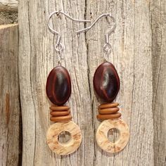 - Tribal style earrings. -They are composed of "Mulatto ears and old women's tongue" seeds as well as young coconut. -Seeds from Guadeloupe, Gwadada, French West Indies :-) -Metal hooks. - Coconut ring made by me (or rather those of my man...) - Coconut in its raw state. Finished by sanding. No varnish is applied. 100% natural. - Non contractual photo. - Sent in a small homemade linen pouch. - FYI do not put the seeds in water. Jute Jewelry Women, Handmade Bohemian Brown Plug Earrings, Handmade Brown Bohemian Plug Earrings, Artisan Brown Earrings For Pierced Ears, Artisan Brown Earrings With Wooden Beads, Artisan Brown Beaded Earrings For Pierced Ears, Unique Brown Wooden Beads Earrings, Brown Wooden Bead Earrings, Traditional Adjustable Wooden Bead Earrings