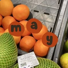 oranges and melons are piled up in a bin with the words family on them