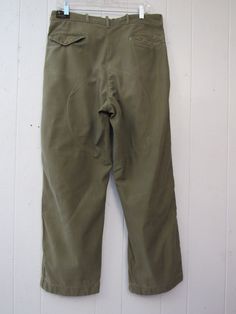 "Vintage 1960s green cotton hunting pants. Has a zip fly, five pockets, suspender buttons, double thick knees and double thick seat. Made by American Field. Actual measurements are: 34\" around the waist 28\" inseam 40\" overall length In good condition with a hole in the waist lining(photo) and some spots. About 4\" of the seat lining stitching is undone(photo)." Khaki Hunting Pants With Pockets, Casual Cotton Hunting Pants, Military Style Cotton Work Pants For Outdoor, Green Cotton Work Pants For Outdoor, Military-style Khaki Bottoms For Hunting, Military Style Khaki Bottoms For Hunting, Vintage Cotton Work Pants With Patch Pockets, Vintage Green Cotton Work Pants, Vintage Green Work Pants With Pockets