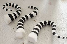 two black and white striped sticks laying on top of a table