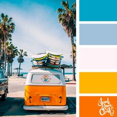 an orange and white vw bus with surfboards on top parked in front of palm trees