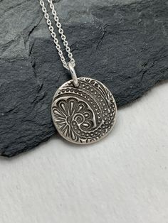 This minimalist tiny paisley necklace has been entirely handmade using .999 fine silver. It has been cut from fine silver precious metal clay, textured, fired and oxidized. The pendant hangs from a sterling silver diamond cut cable chain. This fine silver pendant features an embossed paisley textured pattern on one side of the pendant and is reversible to a completely different embossed paisley pattern on the reverse side. Pendant size: approximately 1/2 x 1/2 inches Chain length: adjustable at Paisley Necklace, Jewelry Layering Bracelets, Jewelry Layering, Precious Metal Clay, Floral Pendant, Layered Bracelets, Bracelet Charm, Silver Diamonds, Necklace Silver