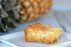 a piece of cake on a plate next to a pineapple