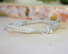 "--- ABOUT THIS BRACELET: This bracelet features a sweet, silver or gold toned treble clef charm, centered in a hand-knotted hemp band in your choice of color. It is finished with an adjustable slide knot closure to ensure the most comfortable fit. Your bracelet will be brand new and handmade-to-order, just for you! --- HEMP COLOR: Choose one from the list of colors. The featured color is Black. Examples of the other colors are in the last pictures. --- CHARM COLOR: Antique silver tone, bright s Music Bracelet, Musician Gifts, Piano Teacher, Treble Clef, Cadiz, Music Lover, Piano Music, Braided Bracelets, Music Lovers