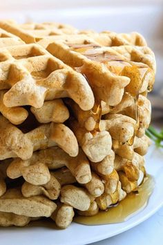 a stack of waffles sitting on top of a white plate