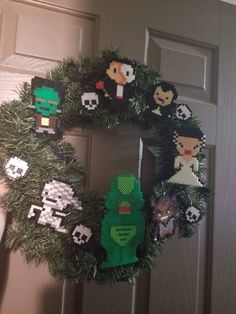 a wreath made out of legos is hanging on the door