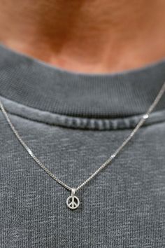 Our Peace Unisex Necklace - a symbol of blessings and a reminder of the gift of life. This pendant, designed for both men and women, carries a profound message: "Peace Necklace" symbolizes freedom and love. Our necklace features a small, delicate pendant that serves as a symbol of finding balance and embracing both the beauty and challenges of the world. It represents the idea that peace starts within us, with ourselves. Whether you're treating yourself or searching for a meaningful gift, this n Sterling Silver Engraved Necklaces For Meditation, Minimalist Sterling Silver Jewelry For Good Luck, Symbolic Sterling Silver Charm Necklace With Adjustable Chain, Sterling Silver Engraved Charm Necklace For Meditation, Symbolic Silver Jewelry With Peace Sign, Spiritual Peace Sign Necklace As A Gift, Everyday Spiritual White Gold Necklaces, Everyday Spiritual White Gold Necklace, Symbolic Sterling Silver Charm Necklaces For Anniversary