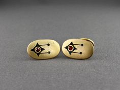 This is a superb pair of Art Deco black enamel and red rhinestone stylized design solid back oval cufflinks. The shiny gold tone cufflinks have a brushed finish with a unique black enamel design that has an inset red rhinestone. This type of cufflink made between 1890s-1910s is called a solid ball back. It has a solid, non moving toggle attached with a curved connector. A nice size, they measure 3/4 inch wide, 1/2 inch tall and 1/16 inch thick. The oval ball back is 1/2 inch wide and 3/8 inch tall. The space between the ball back and panel is 3/8 inch on top and 5/8 inch on the bottom. The cufflinks are in good vintage condition. The shank of each cufflink is signed HA & Co. All items are carefully wrapped, placed in a new gift box and tied with curling ribbon. This item will be shipped vi Curling Ribbon, Vintage Cufflinks, Tie Clips, Red Rhinestone, Tie Accessories, Suit And Tie, Cuff Links, Black Enamel, Vintage Art Deco