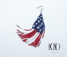 These earrings have been handmade from different shades of blue , shiny pearly white and matte, glossy and metallic red Japanese cylinder beads to create the pattern of the United States of America flag. Although I used over 1700 beads to make these earrings, they are very lightweight. The ear wire is stainless steel. Approximate measurements (including ear wire): Width:    2.5 cm Length:  10 cm Beads:  1700 Weight:  9 grams Patriotic Blue Beaded Earrings, Patriotic White Jewelry With Colorful Beads, Blue Patriotic Beaded Earrings As Gift, Patriotic Blue Beaded Earrings As Gift, Beaded Earrings For 4th Of July Gift, Beaded Earrings As A Gift For 4th Of July, Patriotic Multicolor Beaded Earrings, Handmade Blue Earrings For 4th Of July, Red Jewelry With Ear Wire For Independence Day